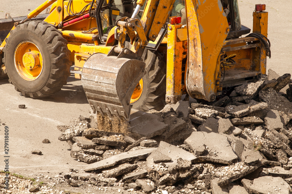 Fototapeta premium Tractor Dismantles Asphalt