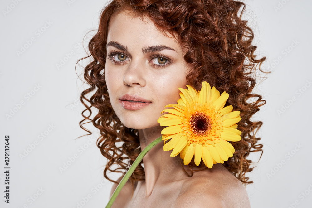 Beautiful woman curly hair flower