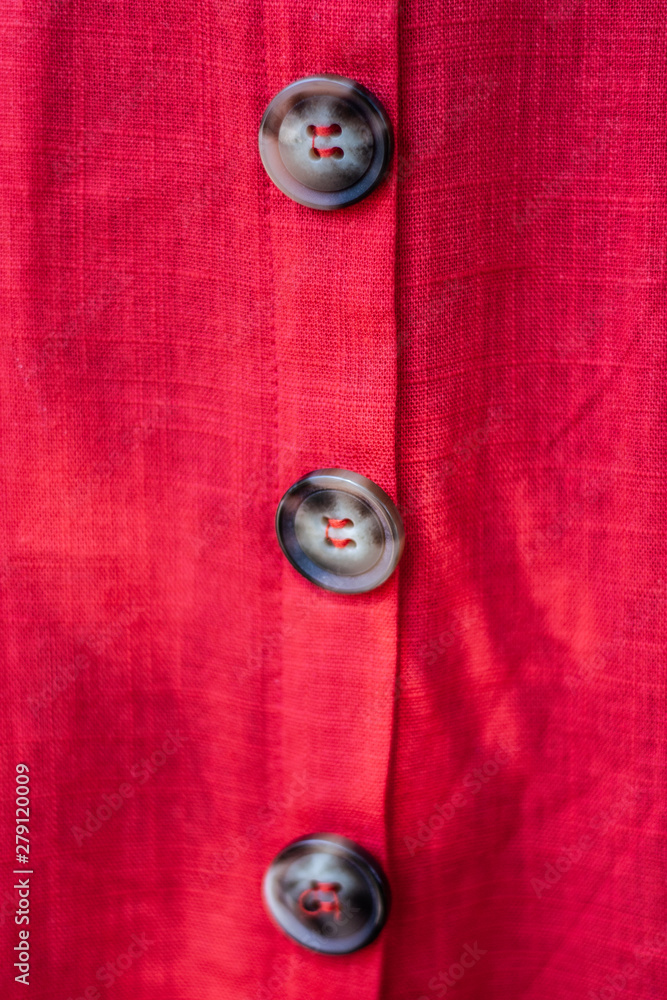 Buttons on red dress macro shot