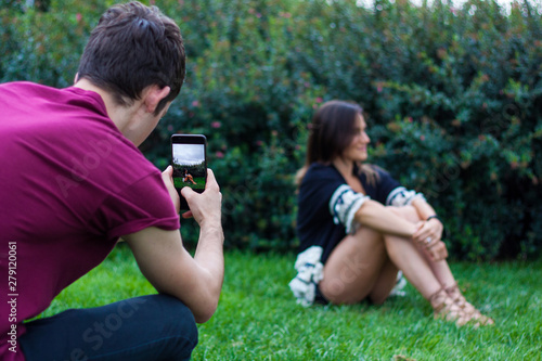 Man taking picture of women with smart phone