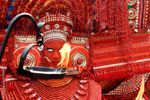 Theyyam is a popular ritual form of worship in Kerala, India,  photo