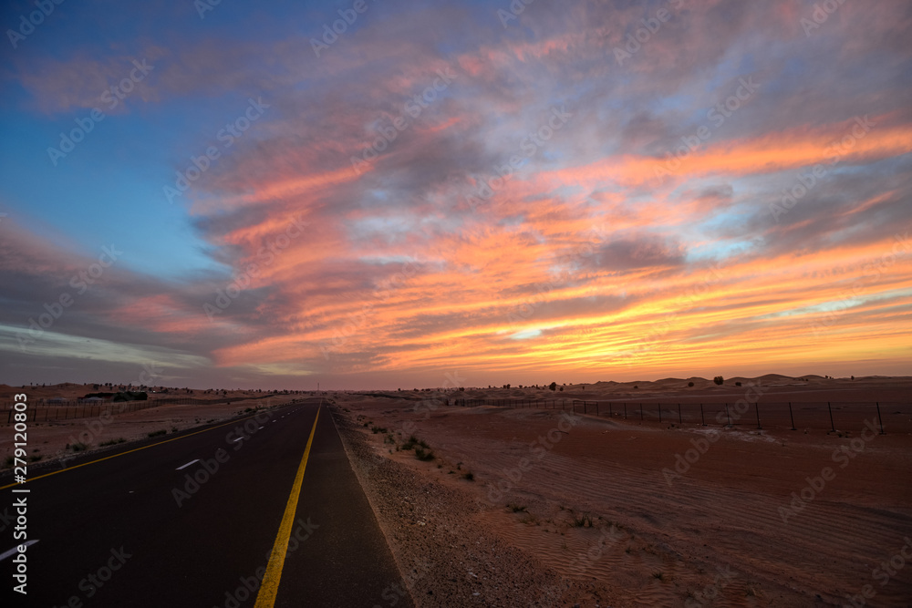 road in the desert at sunset