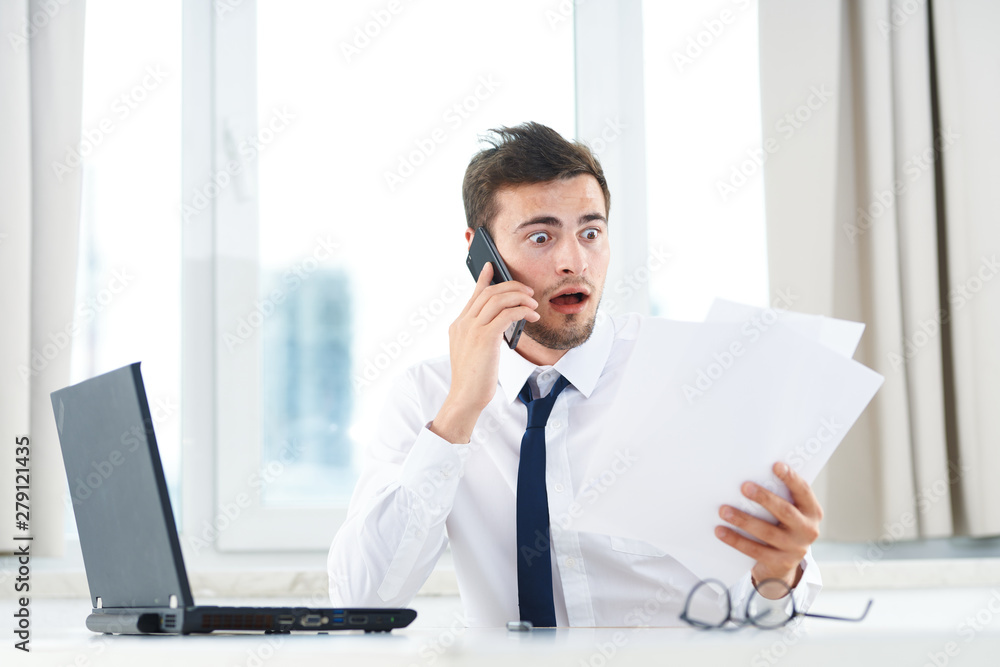 young businessman working on laptop in office young businessman working on laptop in office