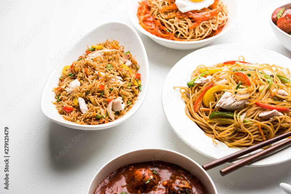 Assorted Indo chinese food in group includes non vegetarian or chicken Schezwan/Szechuan hakka noodles, fried rice, manchurian, egg american chop suey, soup with spoon and chop sticks, selective focus Assorted Indo chinese food in group includes non vegetarian or chicken Schezwan/Szechuan hakka noodles, fried rice, manchurian, egg american chop suey, soup with spoon and chop sticks, selective focus