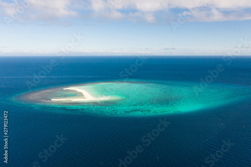 White sandy island with coral reefs.White sandbar.Atoll near the island of Camiguin, Philippines, aerial view.Seascape, white sand island