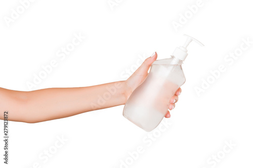 Female hand holding cream bottle of lotion isolated. Girl give cosmetic products on white background