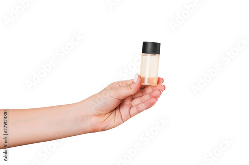 Female hand holding cream bottle of lotion isolated. Girl give tube cosmetic products on white background