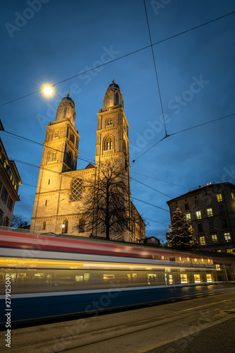 Zurich, Switzerland - view of the Grossmünster church with motion blurred tramway during Chrostmas time photo