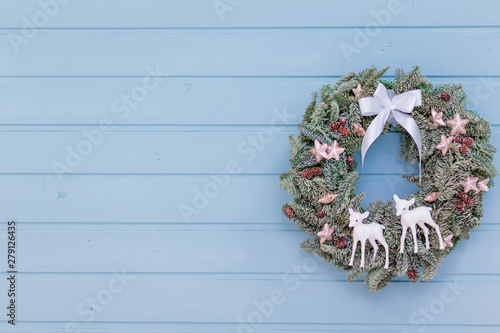 beautiful new year wreath on the blue wooden background