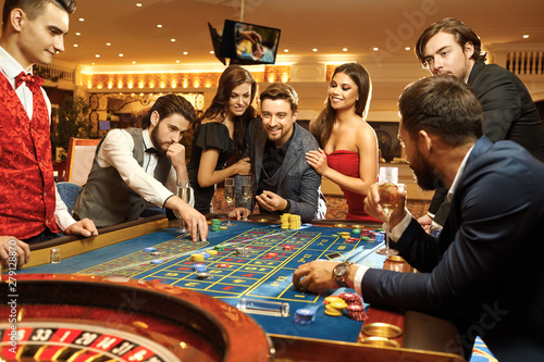 Canvas Print Happy people gambling poker roulette in casino