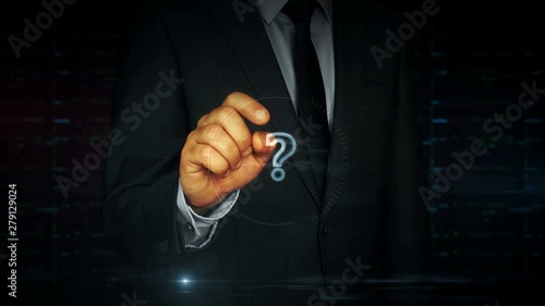 A businessman in a suit touch the screen with question mark symbol hologram. Man using hand on virtual display interface. Knowledge, faq, searching and education concept. photo