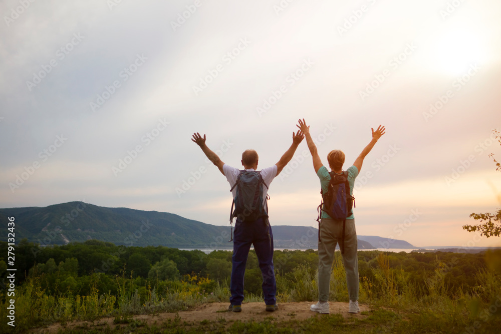 elderly couple on the top of mountain with hands up. Senior couple walking in nature. travel tourism concept elderly couple on the top of mountain with hands up. Senior couple walking in nature. travel tourism concept