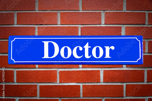 Doctor street sign on brick wall