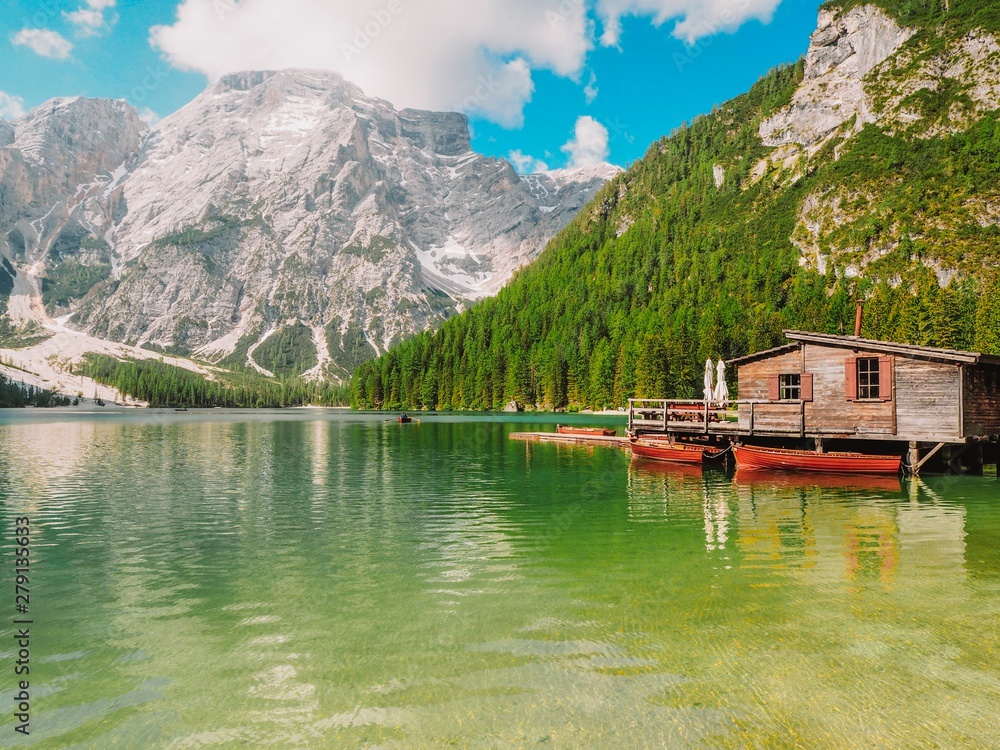 Lake Lago di Braies in Dolomiti mountains, South Tyrol, Italy. Dock with romantic old wooden rowing boats on lake. Amazing view of Lago di Braies, Braies lake, Pragser wildsee