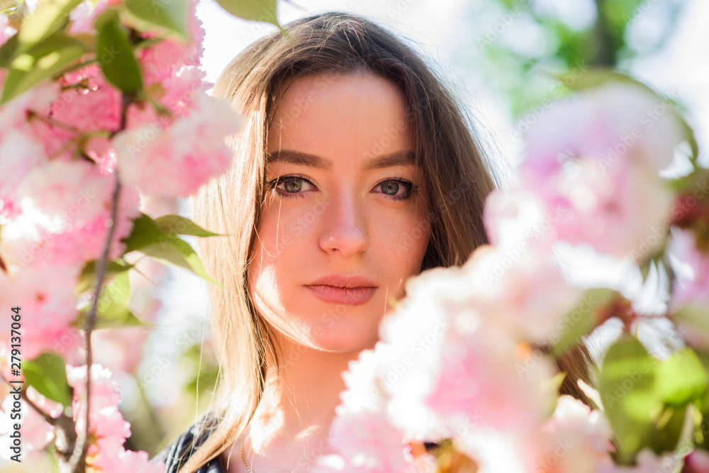 girl in cherry flower. Sakura tree blooming. skincare and spa. Natural cosmetics for skin. natural summer beauty. woman in spring flower bloom. blossom smell, allergy. Spring in pot