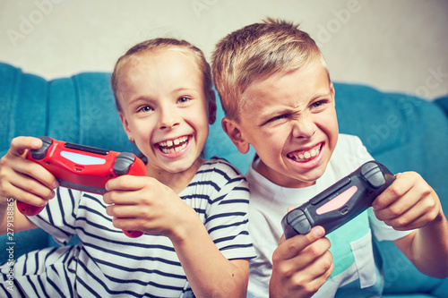 Young kids play video games on their own