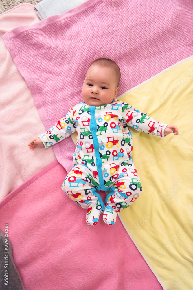 top view of newborn baby boy lying on colorful blankets top view of newborn baby boy lying on colorful blankets
