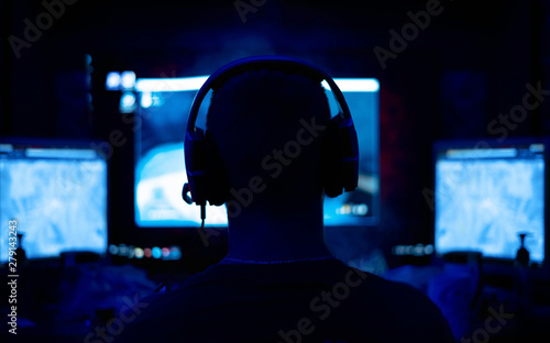 Fototapeta Shot of the Beautiful Pro Gamer Girl Playing in First-Person Shooter Online Video Game on Her Personal Computer