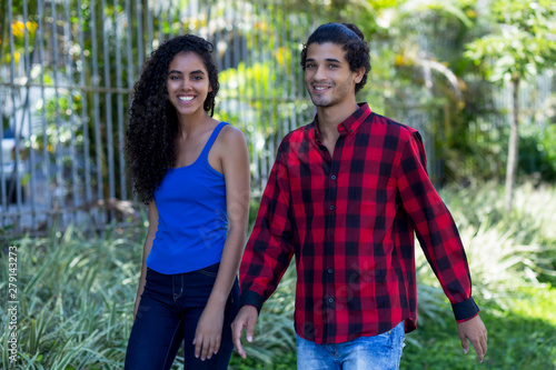 Brazilian hipster couple walking in city