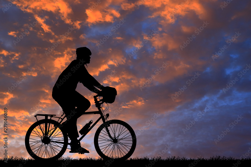Silhouette cycling on blurry sunrise sky background. Silhouette cycling on blurry sunrise sky background.