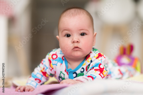 newborn baby boy playing on the floor