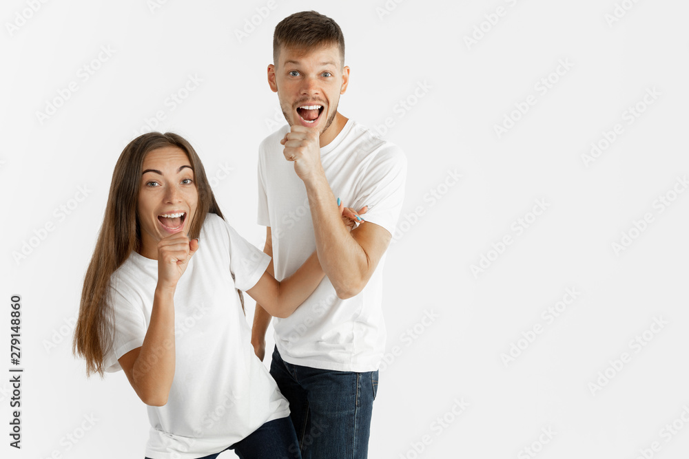 Beautiful young couple's portrait isolated on white studio background. Facial expression, human emotions, advertising concept. Copyspace. Woman and man dancing and singing, look happy together. Beautiful young couple's portrait isolated on white studio background. Facial expression, human emotions, advertising concept. Copyspace. Woman and man dancing and singing, look happy together.