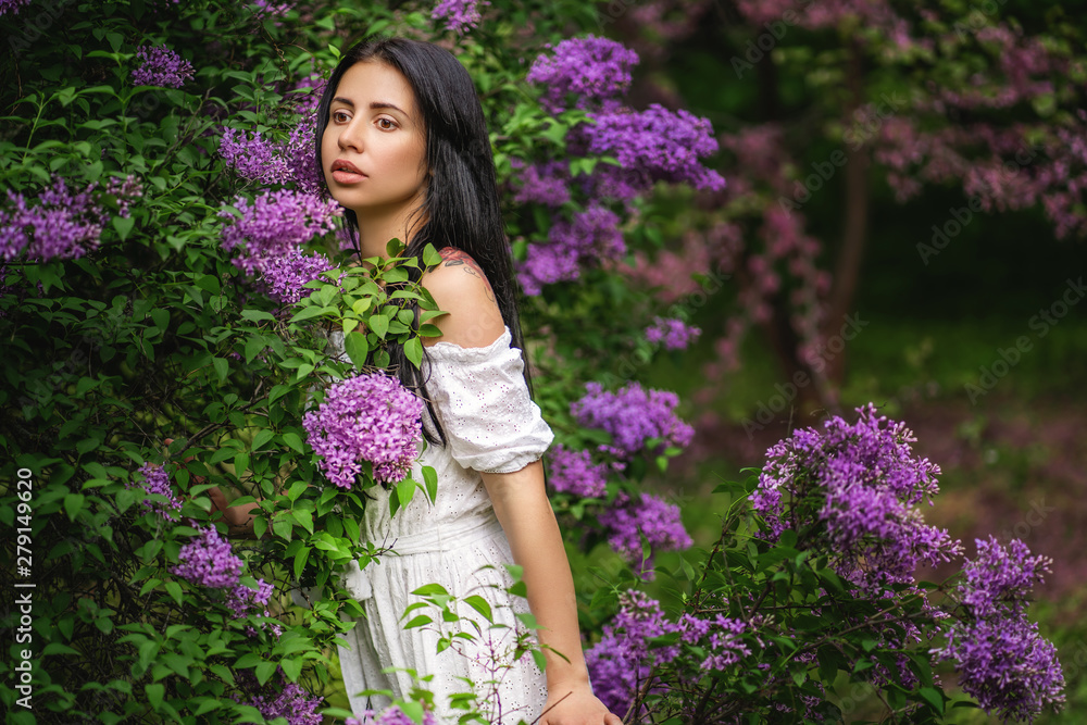 Beautiful young woman near blossoming lilac bush outdoors Beautiful young woman near blossoming lilac bush outdoors