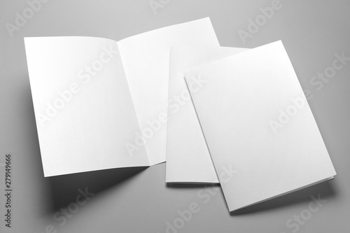 Blank half-folded booklet, postcard, flyer or brochure mockup template on gray background photo