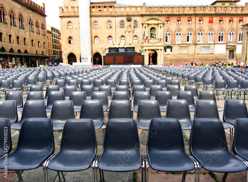 Outdoor cinema, white projection screen, empty chairs. Piazza Maggiore, Bologna, Italy