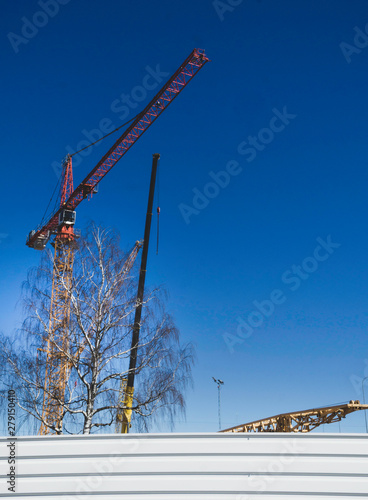 Construction cranes and metal wall