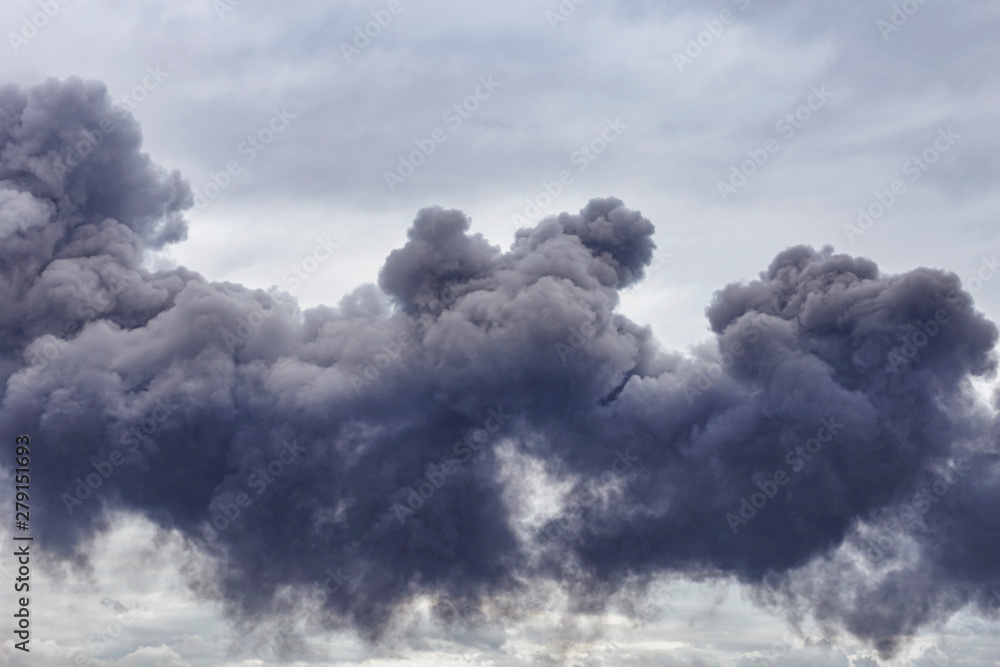 dangerous clouds of black smoke from a burning factory closeup