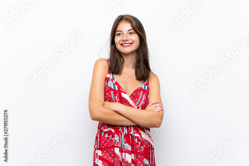 Caucasian girl in red dress over isolated white wall looking up while smiling
