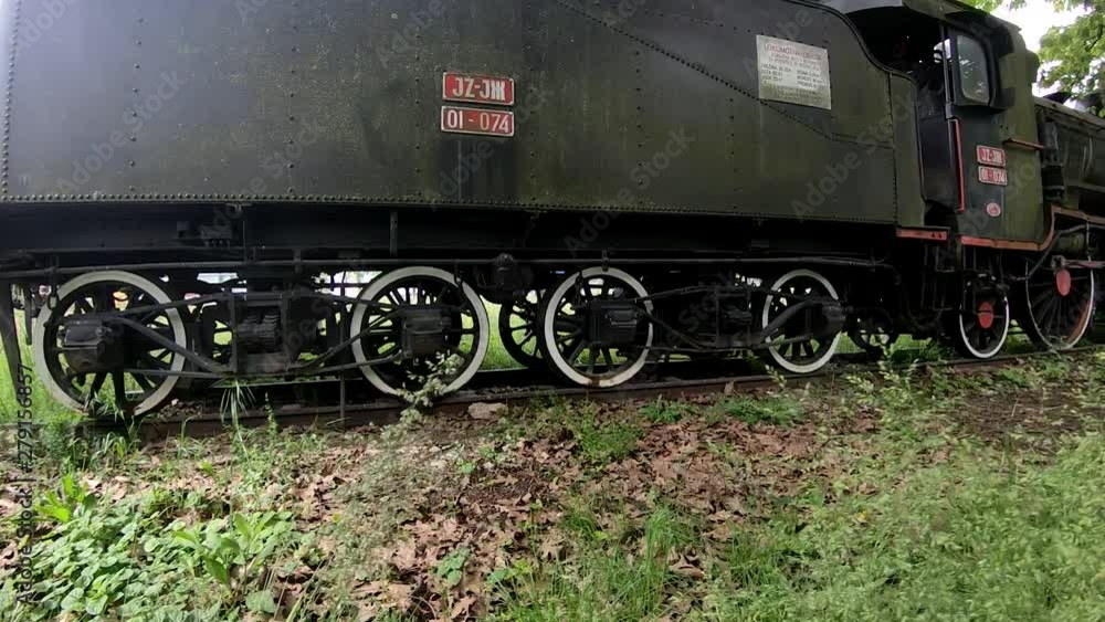 Right side moving view of a museum locomotive parked in a park Right side moving view of a museum locomotive parked in a park