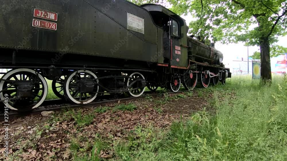 Upward moving view of a museum locomotive parked in a park Upward moving view of a museum locomotive parked in a park