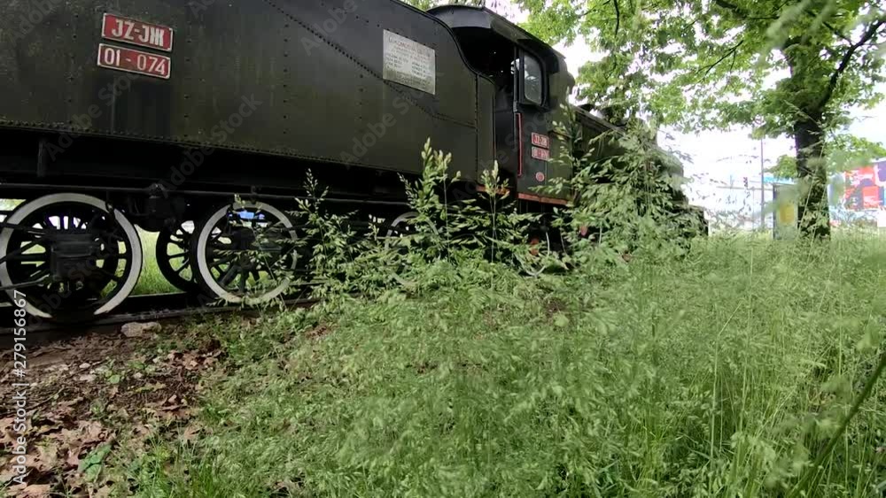 Moving forward, view of a museum locomotive parked in a park Moving forward, view of a museum locomotive parked in a park