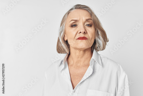 portrait of senior woman with hands on her face