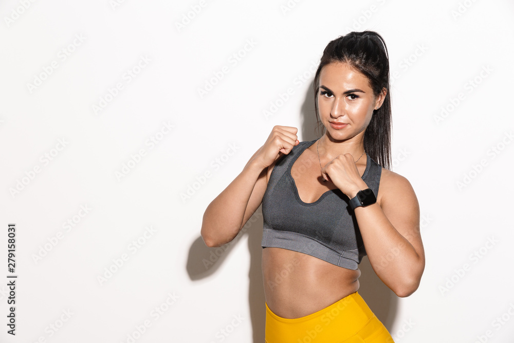 Beautiful amazing young sports fitness woman boxer isolated over white wall background posing. Beautiful amazing young sports fitness woman boxer isolated over white wall background posing.