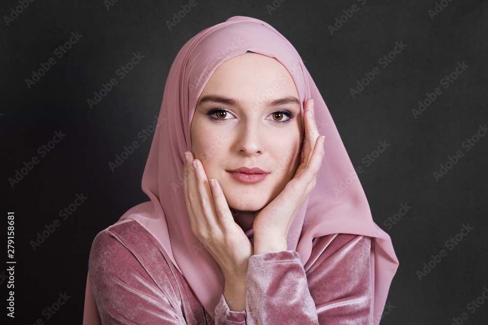 Portrait of muslim woman posing on black background Portrait of muslim woman posing on black background
