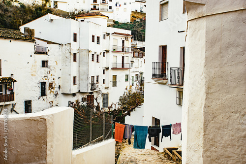 View down a narrow street with washing © sebastiancaptures