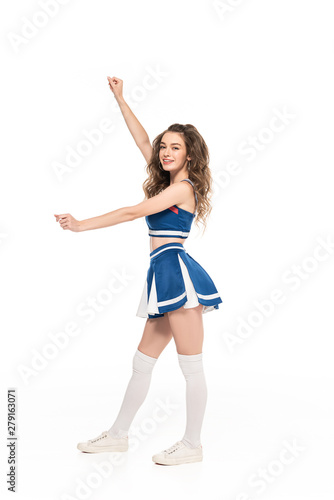 side view of sexy happy cheerleader girl in blue uniform dancing with hands isolated on white