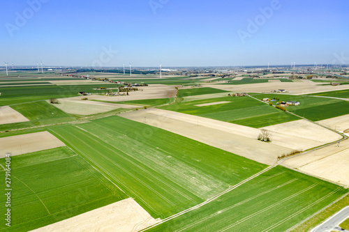 Birds Eye View of the Fields and agricultural parcels.Photo from drone. In the distance, villages and windmills. The contrast of plowed fields and fields that are already sown