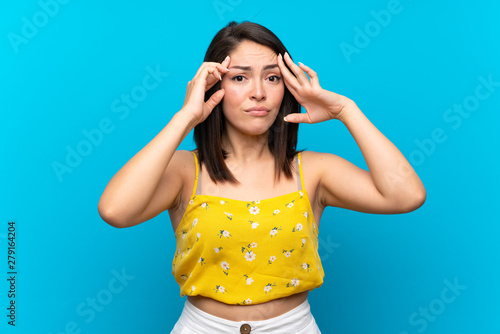 Young Mexican woman over isolated blue background unhappy and frustrated with something. Negative facial expression
