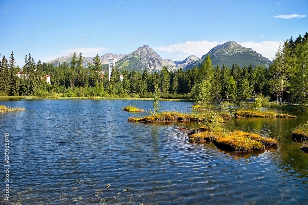 The small islands in the centre of the New Strbske lake in High Tatras to Slovakia.