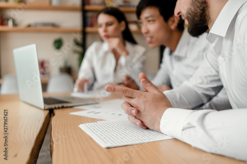 diverse group of businessmen discussing business in the office