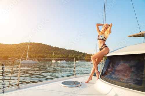 beautiful sexy woman in swimwear relaxing on a yacht front