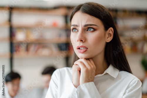 worried businesswoman in the office concerned about company future