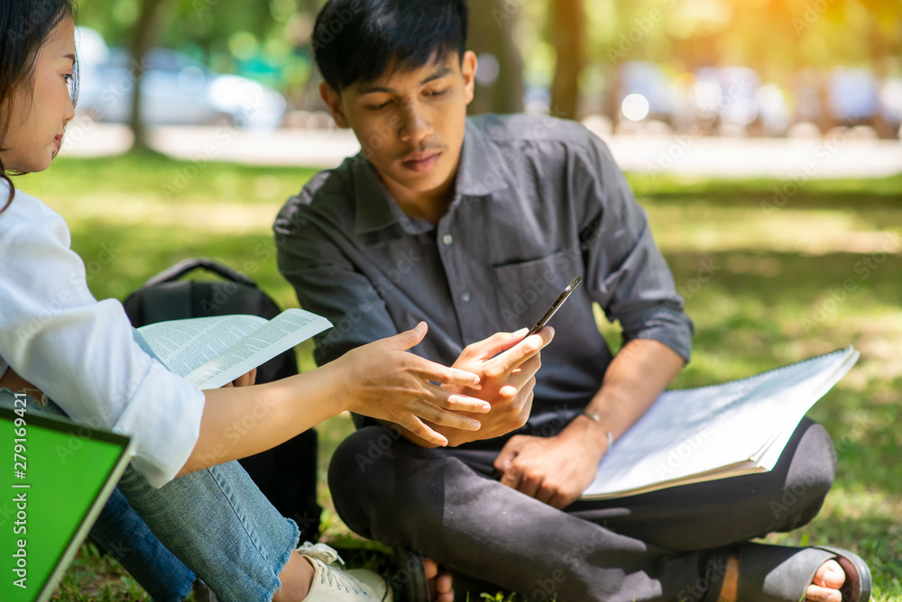 Obraz premium Group of Diversity Student working on laptop and smart phone together at university,Happy multi ethnic friend successfully completes the thesis report and passed the final exam in asian college.