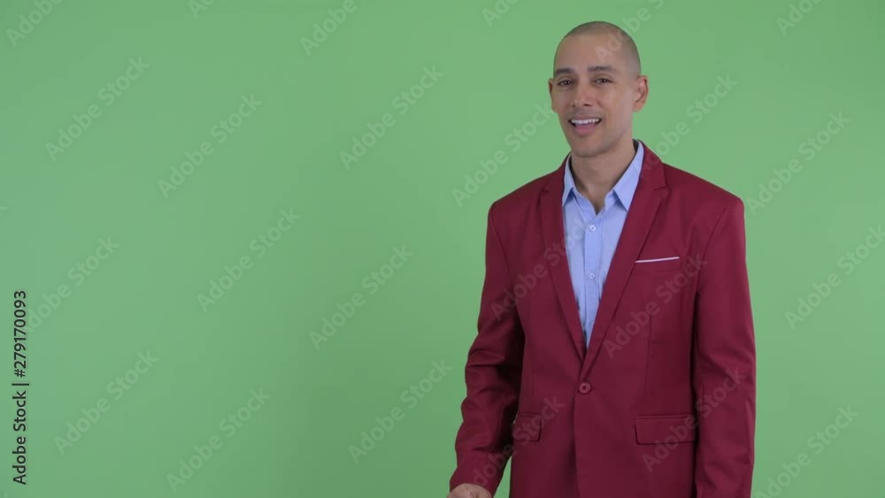 Happy bald multi ethnic businessman snapping fingers and looking surprised Happy bald multi ethnic businessman snapping fingers and looking surprised