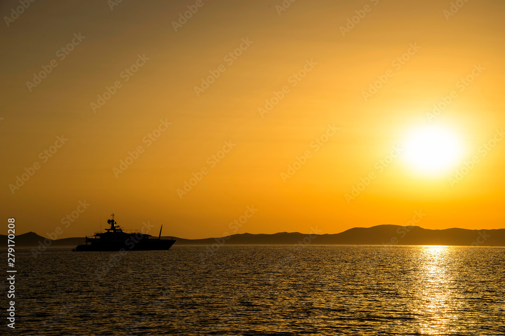 yachts moored at sunset in a bay in Sardinia