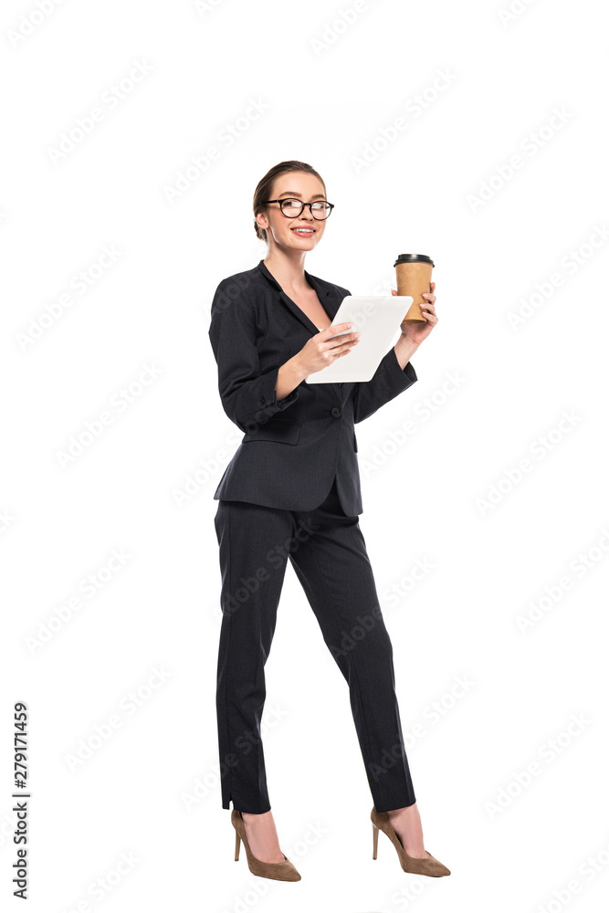 young smiling businesswoman in black suit and glasses holding coffee to go and digital tablet isolated on white young smiling businesswoman in black suit and glasses holding coffee to go and digital tablet isolated on white
